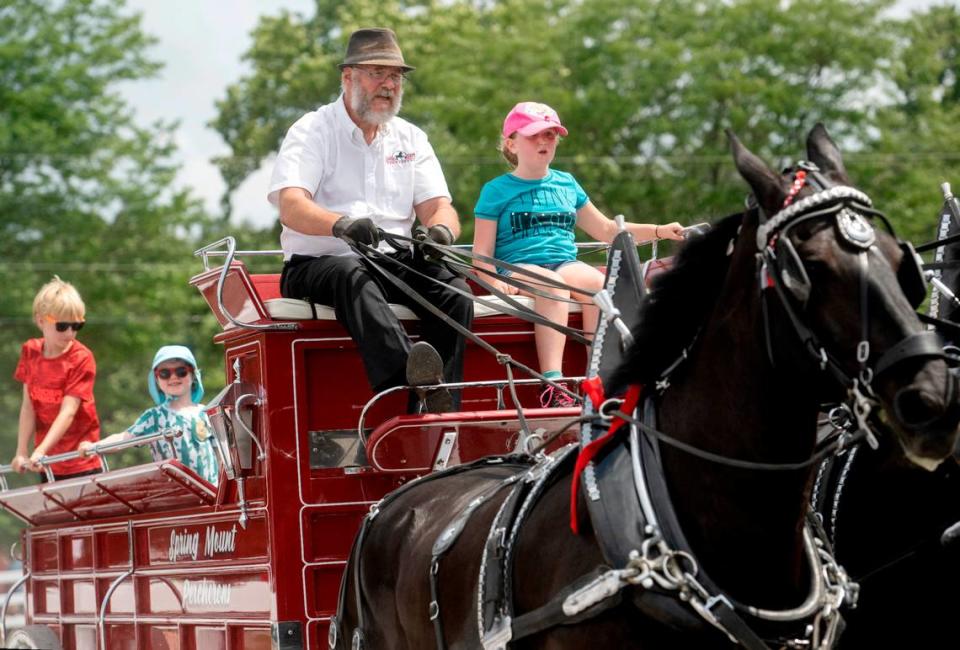 David Hershey of Spring Mount Percherons welcomes several youngsters for a ride with his 6 horse hitch during a draft horse demonstration at Penn State’s Ag Progress Days on Tuesday, Aug. 9, 2022.