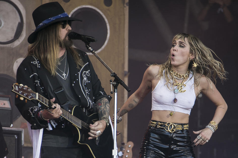 Singers Miley Cyrus, right, and her father Billy Ray Cyrus perform on the final day of Glastonbury Festival at Worthy Farm, Somerset, England, Sunday, June 30, 2019. (Photo by Joel C Ryan/Invision/AP)