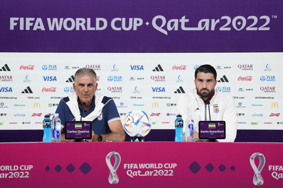 Iran's head coach Carlos Queiroz and Karim Ansarifard attend a press conference on the eve of the group B World Cup soccer match between Iran and the United States in Doha, Qatar, Monday, Nov. 28, 2022. (AP Photo/Ashley Landis)