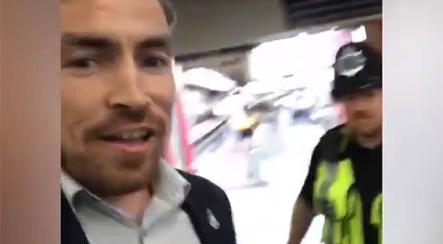 Mr Grant started filming seemingly explaining his predicament, while being pulled away by a police officer in high-vis. Source: Facebook/Andy Grant