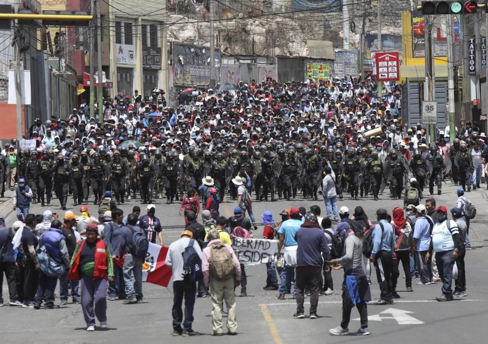 Police arrive where supporters of ousted Peruvian President Pedro Castillo protest his detention in Arequipa, Peru, Wednesday, Dec. 14, 2022. Castillo was detained on Dec. 7 after he was ousted by lawmakers when he sought to dissolve Congress ahead of an impeachment vote. (AP Photo/Fredy Salcedo)