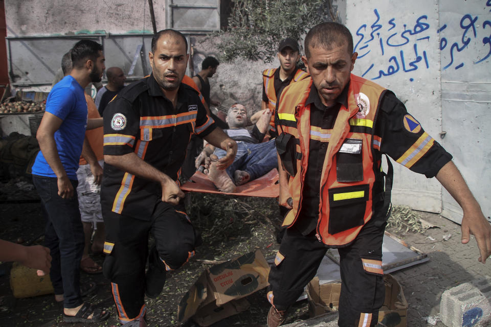 FILE - Members of Palestinian Civil Defense evacuate a wounded man following an explosion in Jebaliya refugee camp, northern Gaza Strip, Sunday, Aug. 7, 2022. (AP Photo/Ahmad Hasaballah, File)