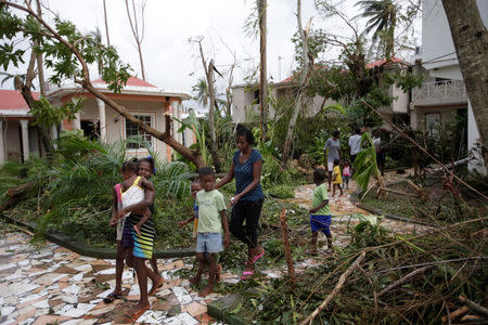 Children walk to a new shelter from Hotel Villa Mimosa where about 200 people were sheltered during Hurricane Matthew in Les Cayes, Haiti, October 6, 2016. REUTERS/Andres Martinez Casares