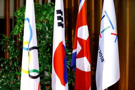 Flags of the International Olympic Committee (IOC), the Republic of Korea (ROK), the Democratic People’s Republic of Korea (DPRK), and the PyeongChang 2018 Organising Committee (POCOG) are seeing at the IOC headquarters in Lausanne, Switzerland, January 20, 2018. REUTERS/Pierre Albouy