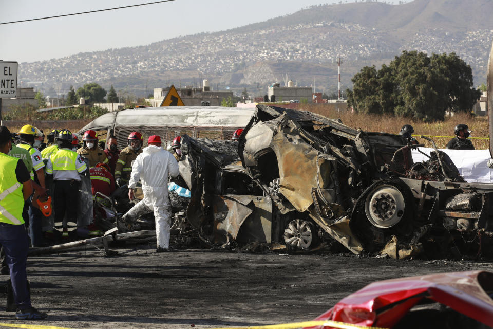 Rescue workers and firefighters work the scene of accident involving multiple vehicles, in Chalco, on the outskirt of Mexico City, Saturday, Nov. 6, 2021. At least 15 people were killed and another five injured in a multiple crash that occurred on a highway in central Mexico on Saturday, firefighters said. (AP Photo)