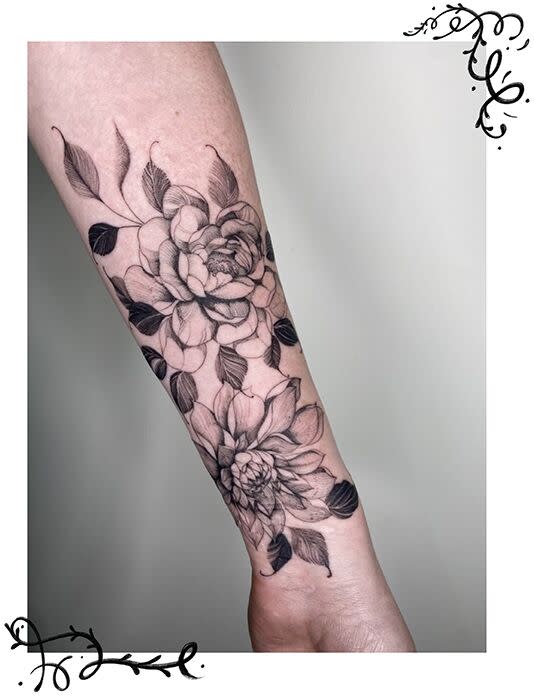 Peony tattoos on an arm.