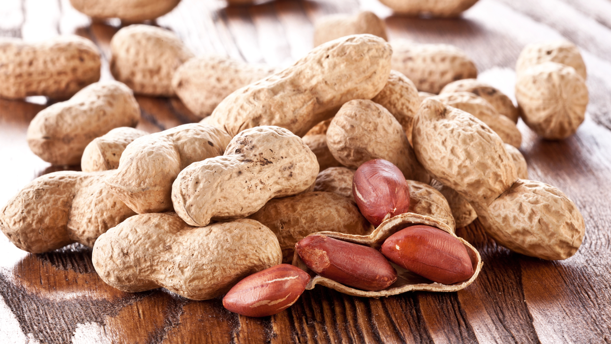 shelled and unshelled peanuts on a table