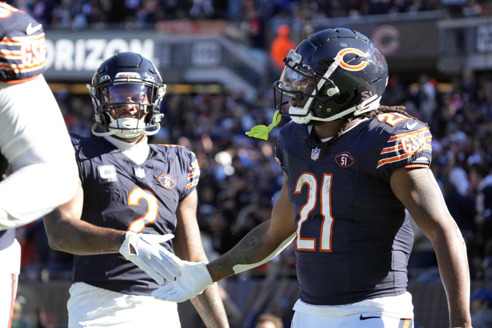 Chicago Bears running back D'Onta Foreman (21) is congratulated by wide receiver DJ Moore (2) in the second half after scoring his third touchdown in an NFL football game against the Las Vegas Raiders, Sunday, Oct. 22, 2023, in Chicago. (AP Photo/Nam Y. Huh)