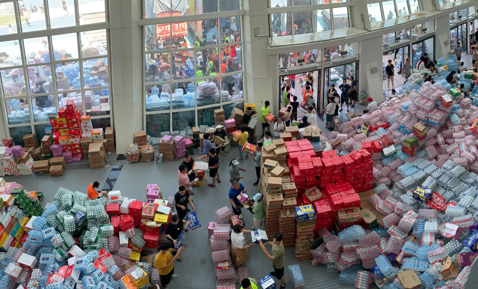 Supplies are stockpiled at the Pingyuan stadium in the flood affected city of Xinxiang in central China's Henan province on Sunday, July 25, 2021. Trucks carrying water and food on Sunday streamed into the Chinese city at the center of flooding that killed over 50 people, while soldiers laid sandbags to fill gaps in river dikes that left neighborhoods under water. (AP Photo/Dake Kang)