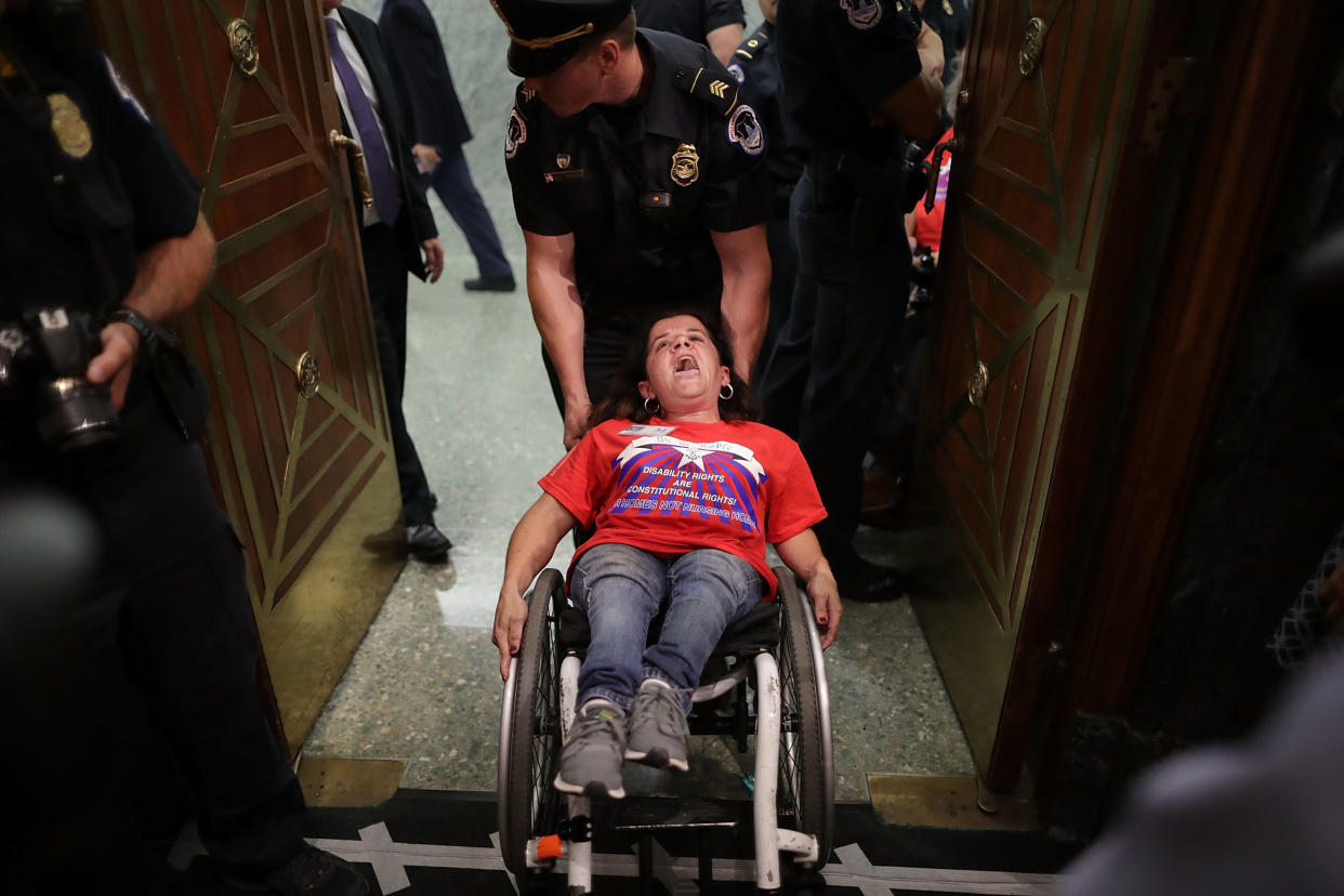 U.S. Capitol Police arrest activists&nbsp;from handicap advocacy organizations as protest during a&nbsp;Senate Finance Committee hearing about the proposed Graham-Cassidy Healthcare Bill in the Dirksen Senate Office Building on Capitol Hill September 25, 2017 in Washington, DC. (Photo: Chip Somodevilla via Getty Images)