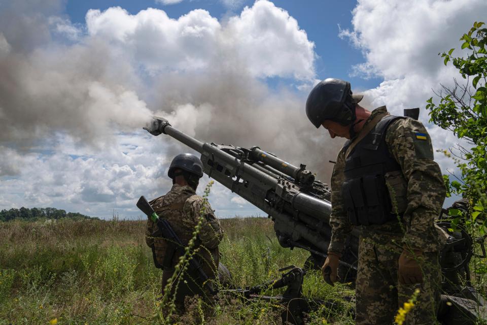 Ukrainian servicemen fire at Russian positions from a U.S.- supplied M777 howitzer in the Kharkiv region, Ukraine, on Thursday, July 14, 2022.