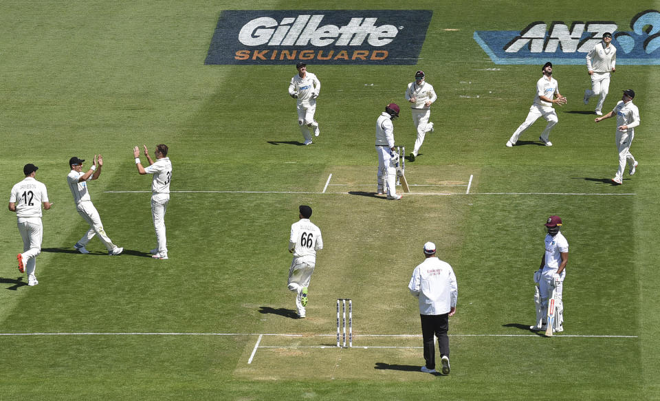 New Zealand's Tim Southee, third left, celebrates after he caught and bowled West Indies' Darren Bravo, center, during play on the second day of their second cricket test at Basin Reserve in Wellington, New Zealand, Saturday, Dec. 12, 2020. (Andrew Cornaga/Photosport via AP)