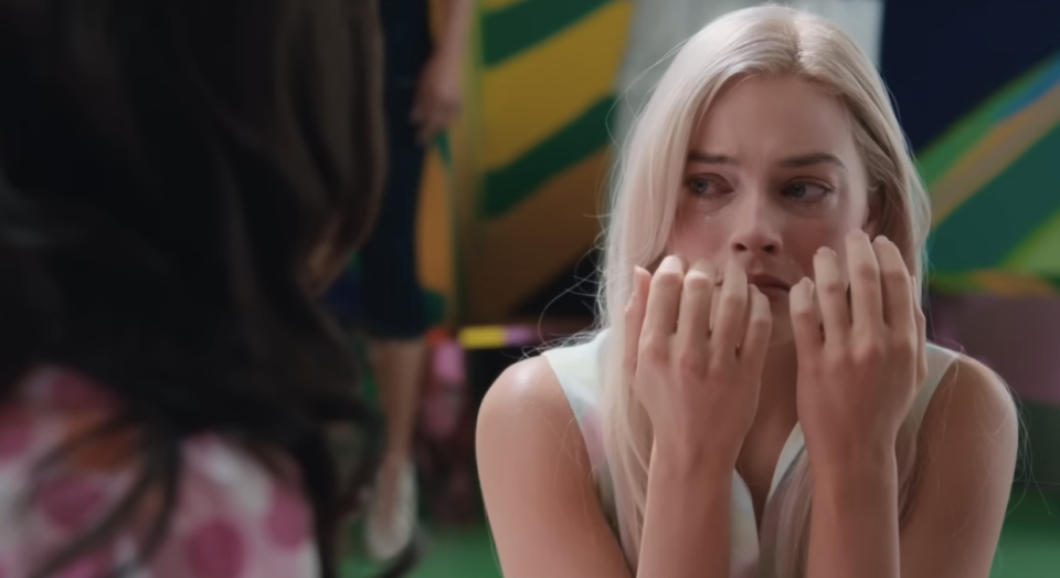 Close-up of Margot in the movie looking at America