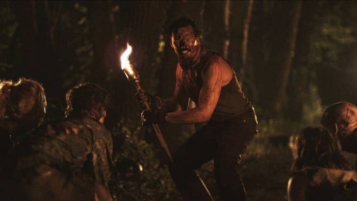 A torch-wielding man attempts to repel a pack of vampires in "Stake Land"