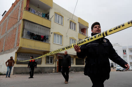 A Turkish police officer secures the area after a building was hit by a rocket fired from Syria, in the border town of Kilis, Turkey January 22, 2018. REUTERS/Osman Orsal