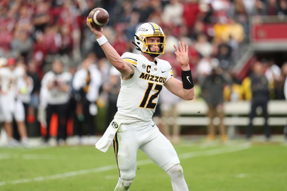 Missouri quarterback Brady Cook (12) throws a pass during the first half of an NCAA college football game against South Carolina, Saturday, Oct. 29, 2022, in Columbia, S.C. (AP Photo/Artie Walker Jr.)