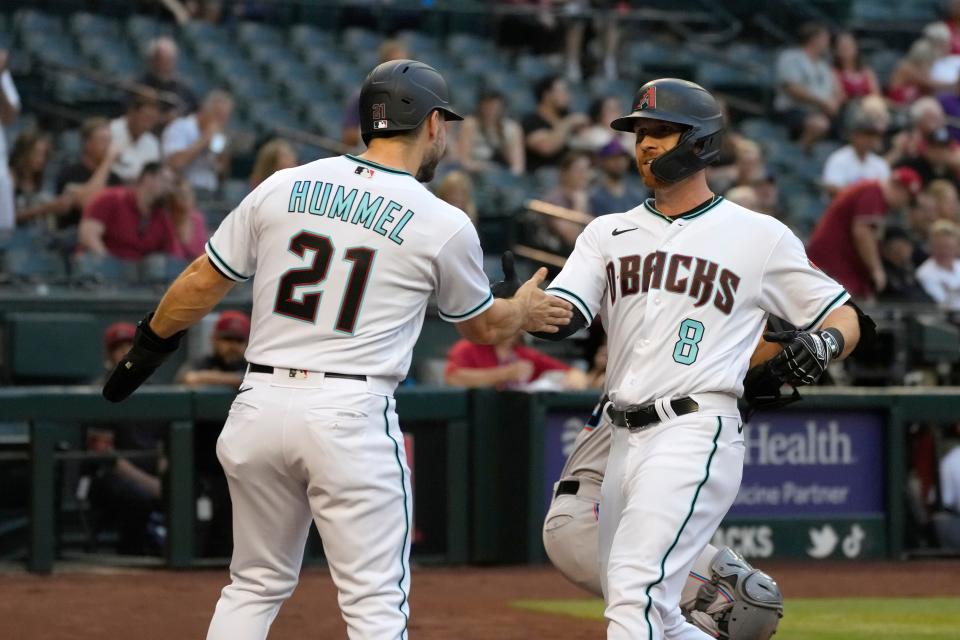 Arizona Diamondbacks Jordan Luplow celebrates with Cooper Hummel (21) after hitting a two run home run against the Miami Marlins in the first inning during a baseball game, Tuesday, May 10, 2022, in Phoenix. (AP Photo/Rick Scuteri)