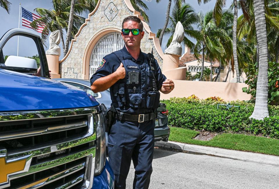 Local law enforcement officers are seen in front of the home of former President Donald Trump at Mar-A-Lag