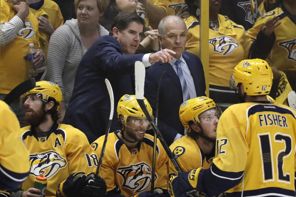 FILE - In this May 7, 2017, file photo, Nashville Predators coach Peter Laviolette, center left, and associated coach Kevin McCarthy, center right, talk during Game 6 of a second-round NHL hockey playoff series against the St. Louis Blues in Nashville, Tenn. The team announced Monday, Jan. 6, 2020, that both Laviolette and McCarthy have been fired. (AP Photo/Mark Humphrey, File)