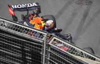 Red Bull driver Max Verstappen of the Netherlands looks over the barrier from his car after hitting a wall during the third free practice session at the Baku Formula One city circuit in Baku, Azerbaijan, Saturday, June 5, 2021. The Azerbaijan Formula One Grand Prix will take place on Sunday. (AP Photo/Darko Vojinovic)