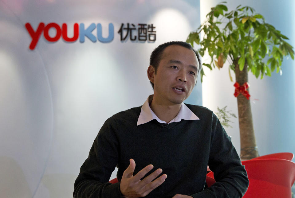 In this Thursday, Dec. 12, 2013 photo, Zhu Huilong, senior vice president of Youku Tudou, answers questions during an interview at the Youku headquarters in Beijing, China. In China, pirate DVDs in stores and on the street were traditionally the fastest way to get access to a film, and cheaper than going to the theater. A few years ago, piracy also dominated online. Today, China’s major video streaming sites have deals with Hollywood studios and others and are filled with licensed content. To protect their investments, a group of video sites announced in November they had teamed up with the Motion Picture Association of America to sue other Chinese sites they accuse of copyright violations. (AP Photo/Ng Han Guan)