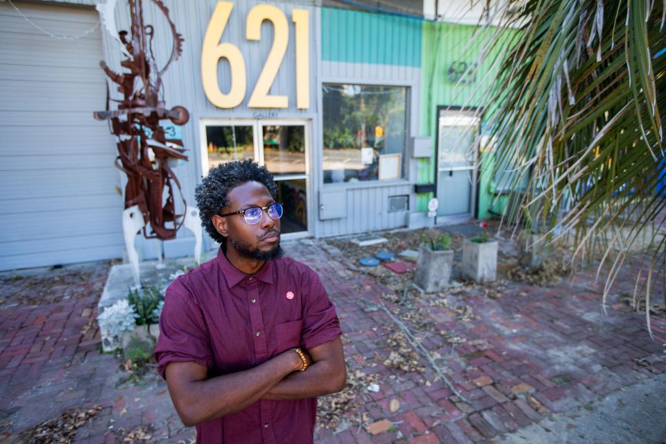 Josh Johnson, owner of 621 Gallery, gazes out at the destruction left behind by tornadoes that tore through Tallahassee a week prior.