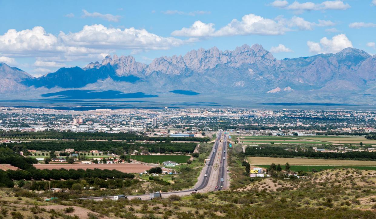 This scenic view shows the city of Las Cruces, New Mexico and the distant Organ Mountains. Interstate 10 is shown entering the city on the west side.
