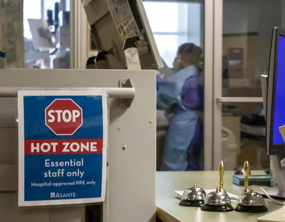 In this Thursday, Aug. 19, 2021, photo, signs delineating the "Hot Zone" are posted at the Critical Care Unit at Asante Three Rivers Medical Center in Grants Pass, Ore. Only essential staff are permitted in the zone, and those who enter a patient's room must don various articles of Personal Protective Equipment. The hospitalization rate of unvaccinated COVID-19 is breaking records and squeezing hospital capacity, with several running out of room to take more patients. (Mike Zacchino/KDRV via AP, Pool)
