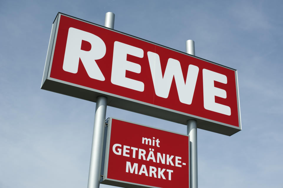 "Limeshain, Germany - March 28, 2012: REWE Sign outside a REWE supermarket.The REWE group is the second biggest food trader in Germany.  REWE is a German Supermarket chain and headquartered at Cologne. It is part of the REWE Group which operates in 14 European countries."