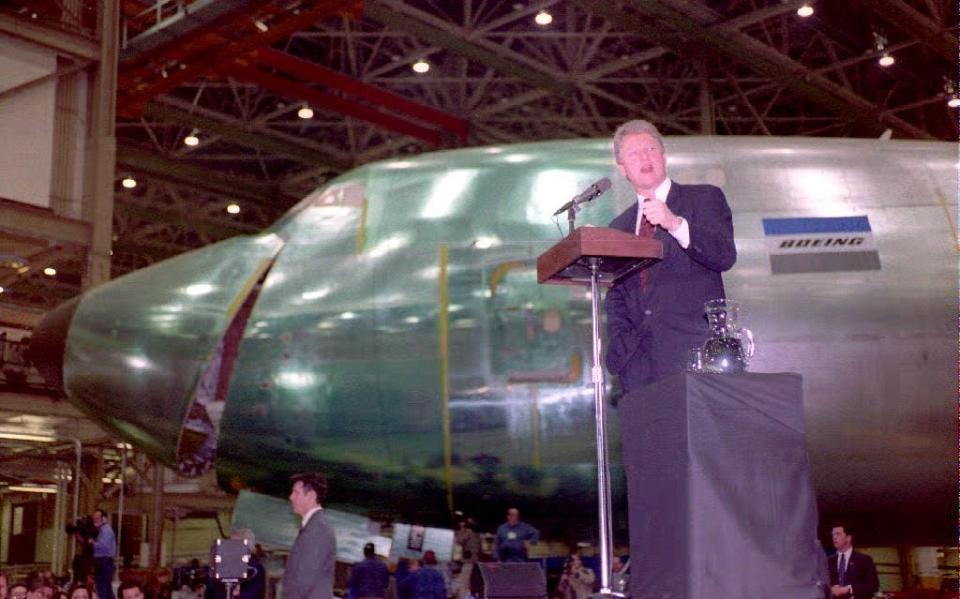 U.S. President Bill Clinton addresses Boeing employees 22 February 1993 in Washington. The nose of the latest Boeing 747-400 cargo plane is in the background.