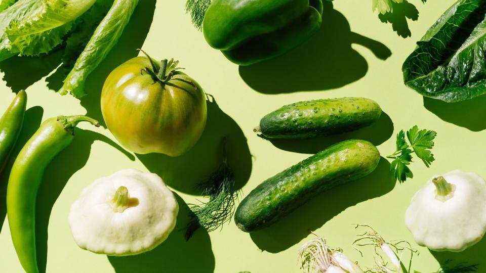 Collection of green vegetables, including cucumber, lettuce, and spring onions