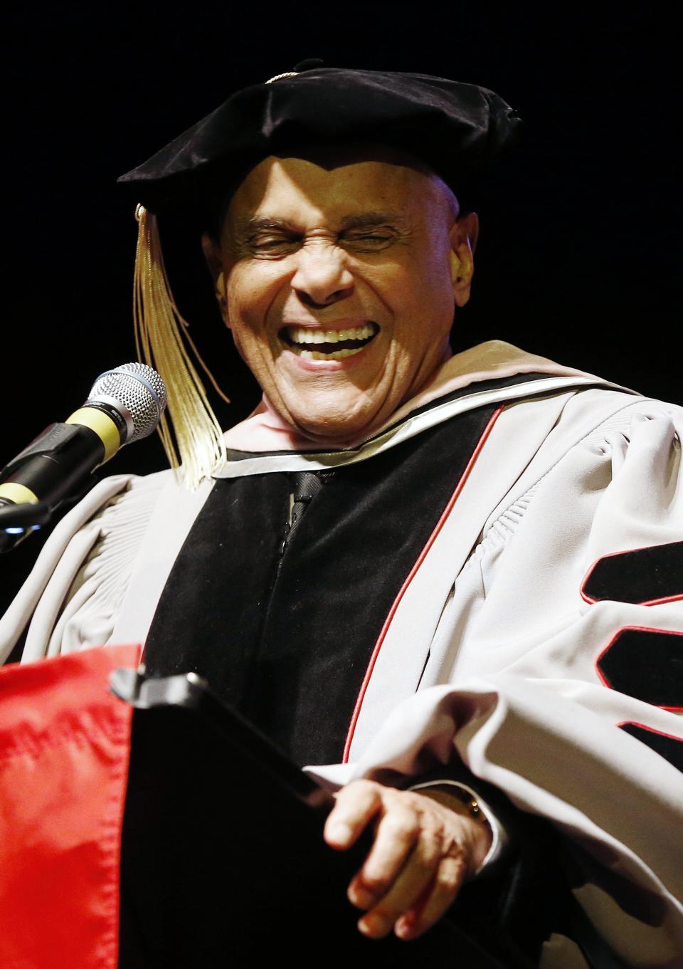 Harry Belafonte laughs while speaking after receiving an honorary doctor of music from Berklee College of Music at the Berklee Performance Center in Boston, Thursday, March 6, 2014. (AP Photo/Michael Dwyer)