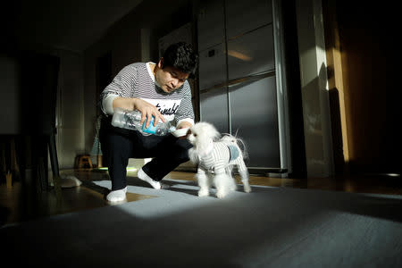 Kang Sung-il, a pet funeral manager, feeds water to his pet dog Sancho at his home in Incheon, South Korea, January 15, 2019. REUTERS/Kim Hong-Ji