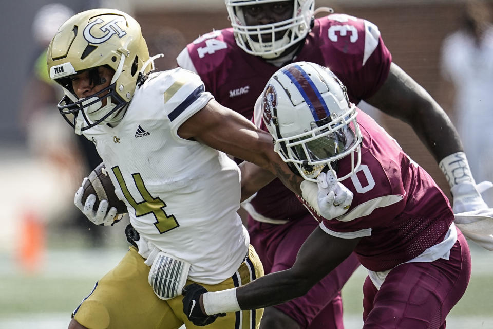 Georgia Tech running back Dontae Smith (4) runs against South Carolina State defensive back Malcolm Magee (0) during the first half of an NCAA college football game, Saturday, Sept. 9, 2023, in Atlanta. Smith caught a penalty for facemasking. (AP Photo/Mike Stewart)