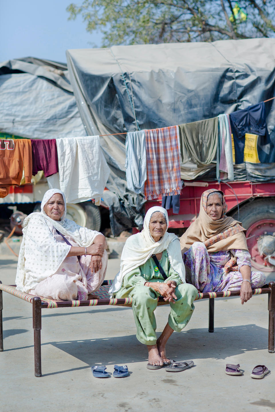 The protests have drawn women of all ages. While some speak onstage, others are simply determined to be present. “I am an illiterate woman,” says Gurmer Kaur, center, at the protests with her friends Surjit Kaur, left, and Jaswant Kaur, right, all in their mid-70s. “I cannot talk well, but I can sit tight—and I will sit here till the next elections if these laws are not called off.”<span class="copyright">Kanishka Sonthalia for TIME</span>