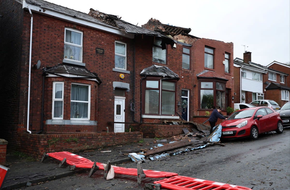 Damage pictured on the roofs of a row of terraced houses in Stalybridge (REUTERS)