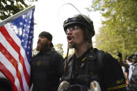 Members of the Proud Boys and other right-wing demonstrators rally on Saturday, Sept. 26, 2020, in Portland, Ore. (AP Photo/Allison Dinner)