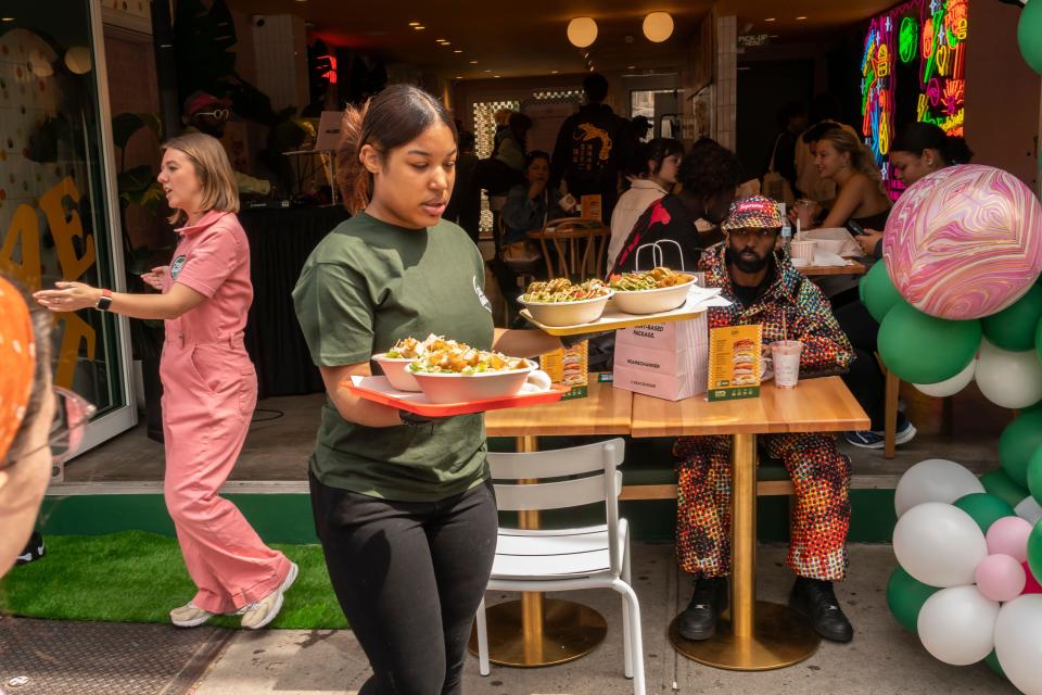 UK business confidence: Waitress serves food at restaurant chain 