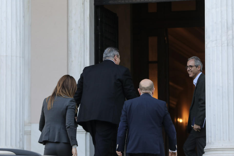 Greek Defense Minister Panos Kammenos, second left, arrives for a meeting with Greece's Prime Minister Alexis Tsipras, in Athens, Sunday, Jan. 13, 2019. Greek defense Minister Kammenos, leader of the right-wing populist Independent Greeks party, is vehemently opposed to a deal with neighboring Macedonia over its state name. (AP Photo/Yorgos Karahalis)