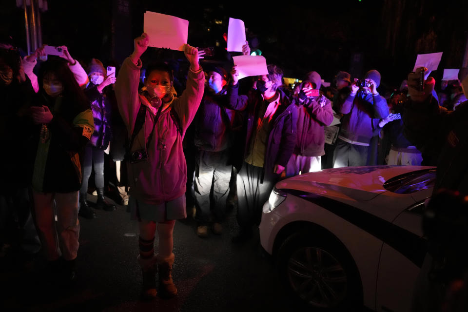 FILE - Protesters hold up blank papers and chant slogans as they march in protest in Beijing on Nov. 27, 2022. The widespread resolve against Russia's invasion of Ukraine demonstrates the power of a unified response against human rights abuses, a leading watchdog group said Thursday, Jan. 12, 2023, and comes amid growing dissatisfaction with autocratic regimes, with protests in Iran, China and elsewhere. (AP Photo/Ng Han Guan, File)