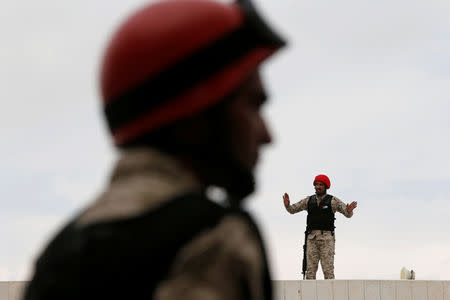 Jordanian security personnel stand guard during the trial of those accused of staging an attack on December 2016 on a Crusader castle in Kerak, at the State Security Court in Amman, Jordan November 13, 2018. REUTERS/Muhammad Hamed