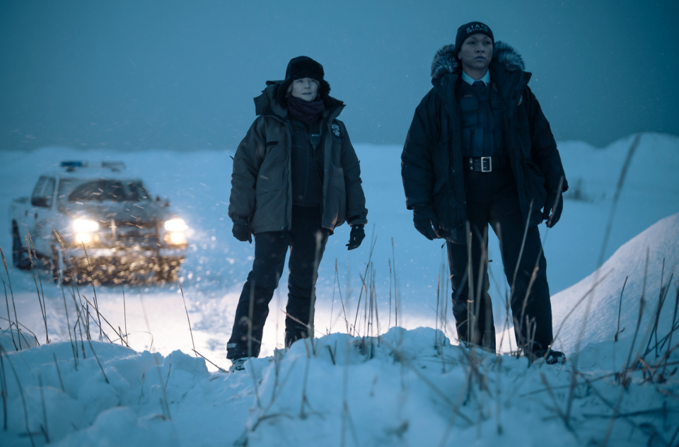 two people standing in the snow