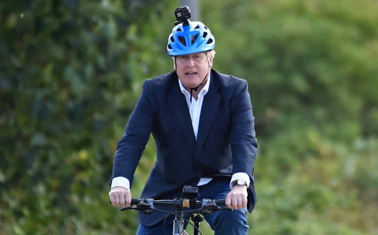 Boris Johnson rides a bicycle at the Canal Side Heritage Centre in Beeston to launch a strategy to get more people cycling - Rui Vieira/PA
