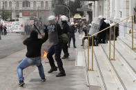 <p>A protester attacks with a hammer to a riot police officer during clashes at a nationwide general strike demonstration, in Athens Wednesday, May 17, 2017. Greek workers walked off the job across the country Wednesday for an anti-austerity general strike that was disrupting public and private sector services across the country. (AP Photo/Thanassis Stavrakis) </p>