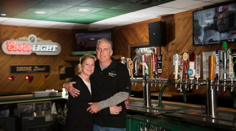 Lori and Jimmy Mulligan, owners of Mulligan's Bar & Grill, stand behind their bar in Oaklyn. Mulligan's will be ready for St. Patrick's Day.