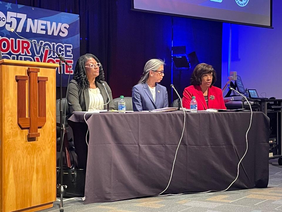 LaQuita Hughes, left, sits next to South Bend Common Council members Rachel Tomas Morgan, center, and Karen White, right. Hughes, a small business owner and pastor, looks to seat one of three incumbents.