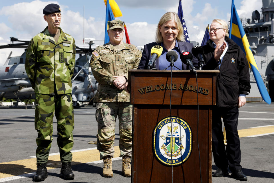 From left, Swedish Armed Forces Commander-in-Chief Micael Bydén, Army Gen. Mark Milley, chairman of the Joint Chiefs of Staff, and Swedish Prime Minister Magdalena Andersson and Sweden's Minister of Defense Peter Hultqvis aboard the American amphibious warship USS Kearsarge in Stockholm, Saturday, June 4, 2022. (Fredrik Persson/TT News Agency via AP)