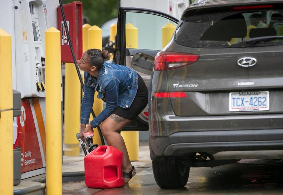 Customers fill up their automobiles and gas containers with fuel at the Circle K on Avent Ferry Road on Wednesday, May 12, 2021 in Raleigh, N.C. The cyberattack on the Colonial Pipeline has spread fears of a gas shortage, with long lines forming at stations that have a supply.