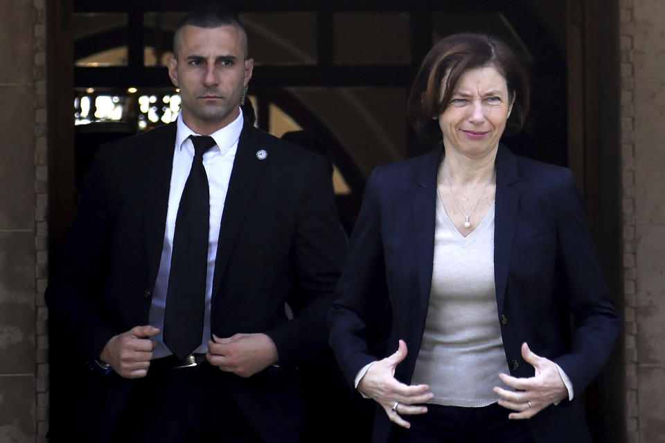 France's Defense Minister Florence Parly, right, leaves the Presidential Palace after talks with Cypriot President Nicos Anastasiades in capital Nicosia, Cyprus, Tuesday, Feb. 18, 2020. Parly said on Tuesday that her country stands in solidarity with Cyprus amid tensions over a Turkish search for natural gas inside Cypriot waters. (AP Photo/Petros Karadjias)