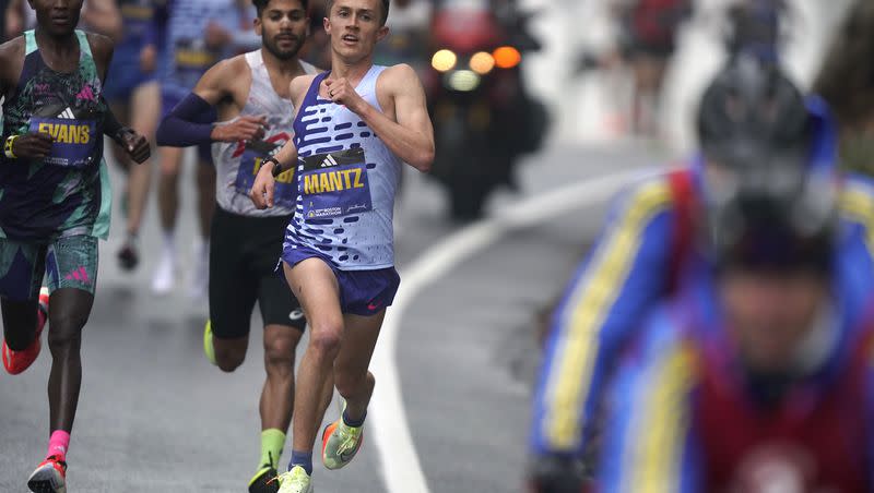 Former BYU runner Conner Mantz, center, runs near Evans Chebet, of Kenya, left, during the 127th Boston Marathon on April 17, 2023, in Ashland, Mass. The former BYU All-American will be among the favorites competing Saturday at the Olympic Marathon Trials in Orlando.